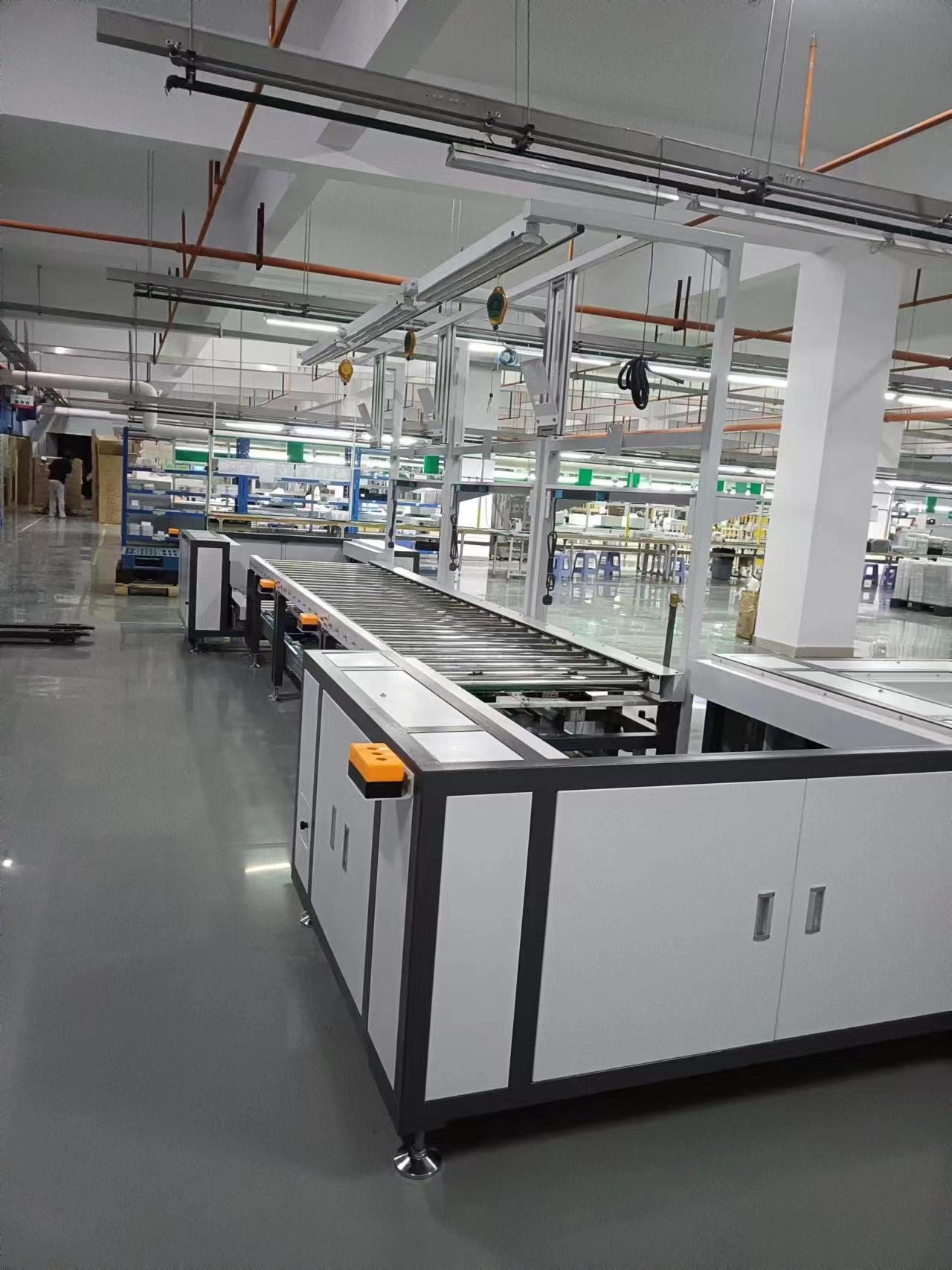 Automated pallet conveyor system with control cabinet and overhead rail structure in assembly production line